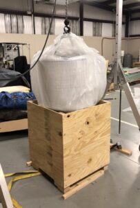 Lowering the cage and electronics into the shipping box